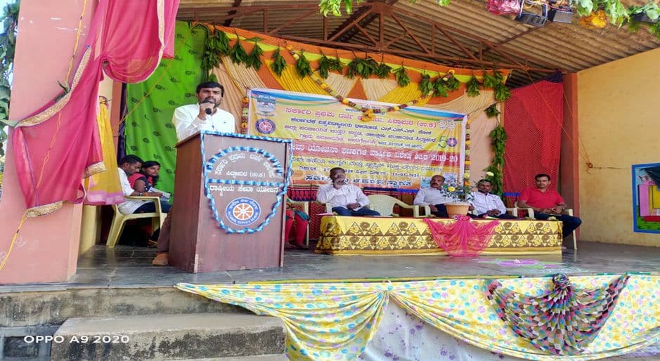 A speaker addresses an outdoor stage programme