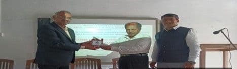 Mr. Dattatraya Joshi and Mr. Vivek Hegde presenting a memento to Principal Dr. S.S. Guttikar