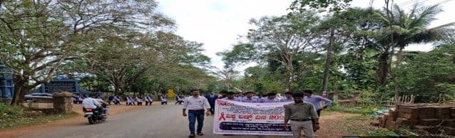 Students carrying the World AIDS Day banner through Siddapur