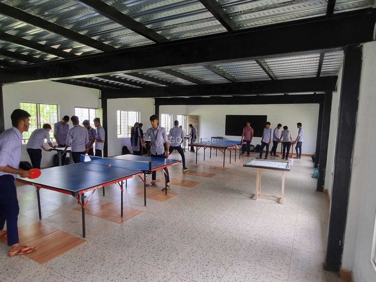 Students playing table tennis in the indoor games hall